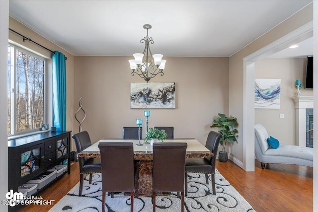 7865 S Settlers Bay Dr, Wasilla, AK 99623 - dining area with baseboards, wood finished floors, and a chandelier