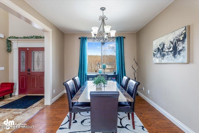7865 S Settlers Bay Dr, Wasilla, AK 99623 - dining room featuring an inviting chandelier, baseboards, and dark wood-type flooring