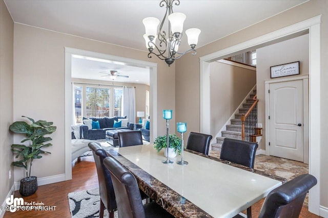 7865 S Settlers Bay Dr, Wasilla, AK 99623 - dining space featuring baseboards, wood finished floors, stairway, and ceiling fan with notable chandelier