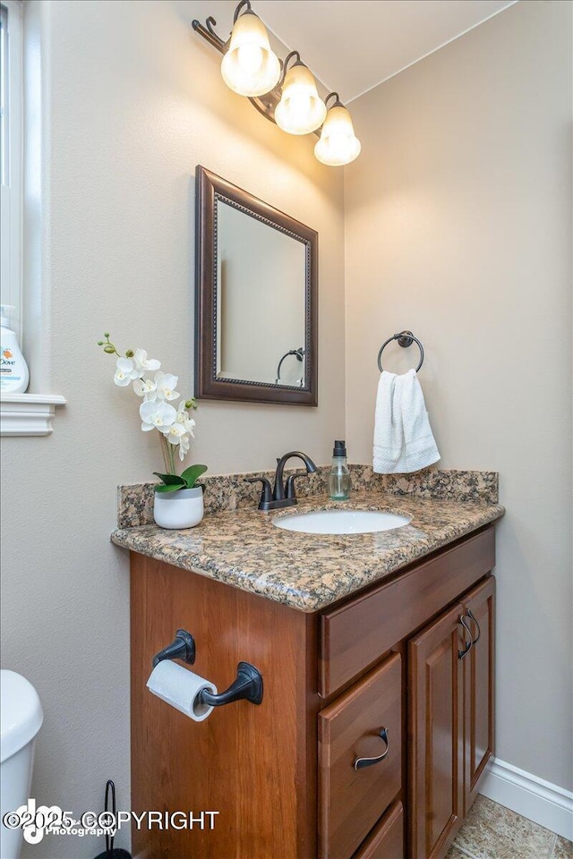 7865 S Settlers Bay Dr, Wasilla, AK 99623 - half bath with vanity, baseboards, and toilet