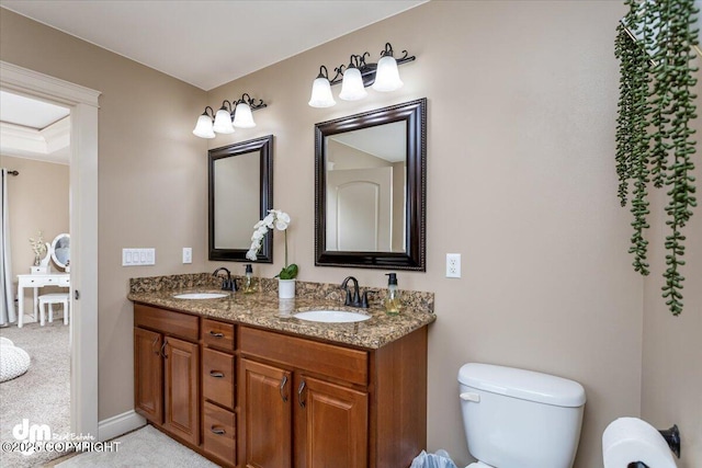 7865 S Settlers Bay Dr, Wasilla, AK 99623 - bathroom featuring double vanity, toilet, and a sink