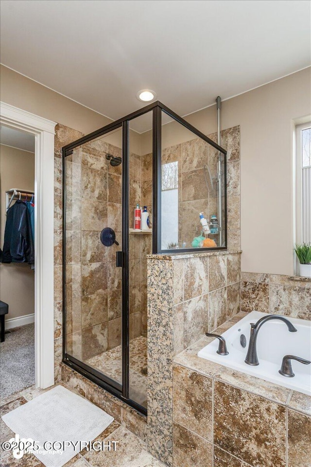 7865 S Settlers Bay Dr, Wasilla, AK 99623 - bathroom featuring a shower stall, a walk in closet, a garden tub, and a wealth of natural light