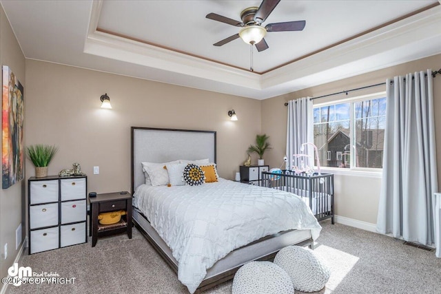 7865 S Settlers Bay Dr, Wasilla, AK 99623 - bedroom with carpet floors, a ceiling fan, baseboards, and a tray ceiling