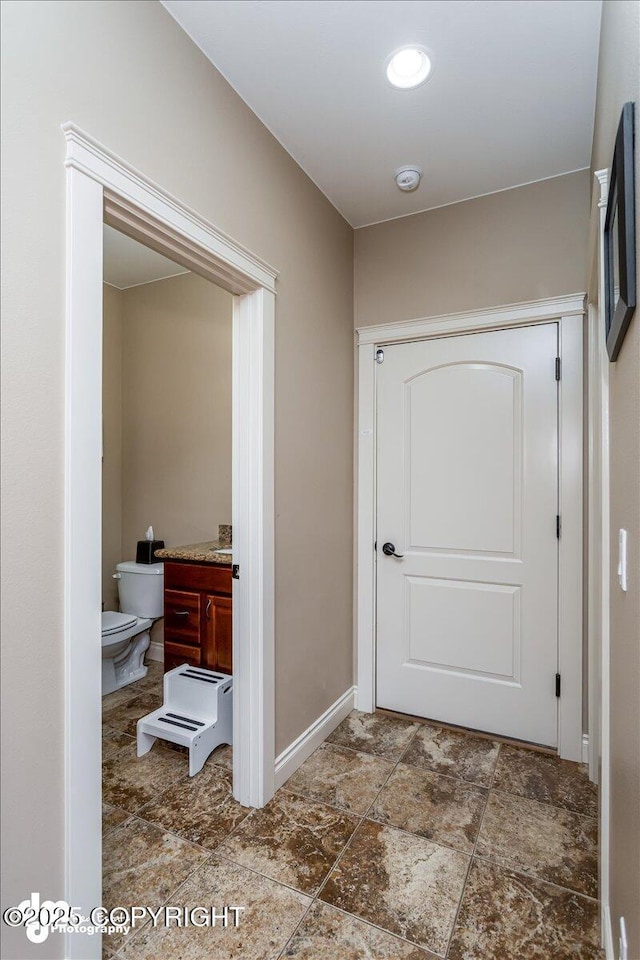7865 S Settlers Bay Dr, Wasilla, AK 99623 - hallway with baseboards and stone finish floor