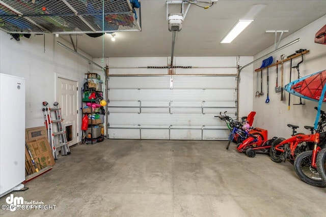 7865 S Settlers Bay Dr, Wasilla, AK 99623 - garage with a garage door opener and freestanding refrigerator