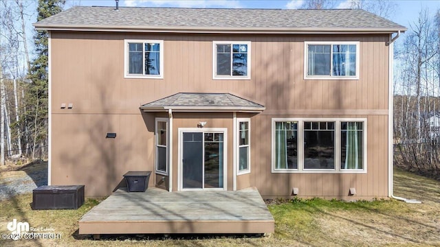 7865 S Settlers Bay Dr, Wasilla, AK 99623 - back of property featuring a lawn, a wooden deck, and a shingled roof