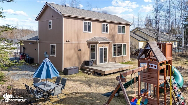 7865 S Settlers Bay Dr, Wasilla, AK 99623 - rear view of house featuring a playground, a wooden deck, and a shingled roof