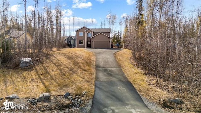 7865 S Settlers Bay Dr, Wasilla, AK 99623 - traditional-style house with driveway and a garage