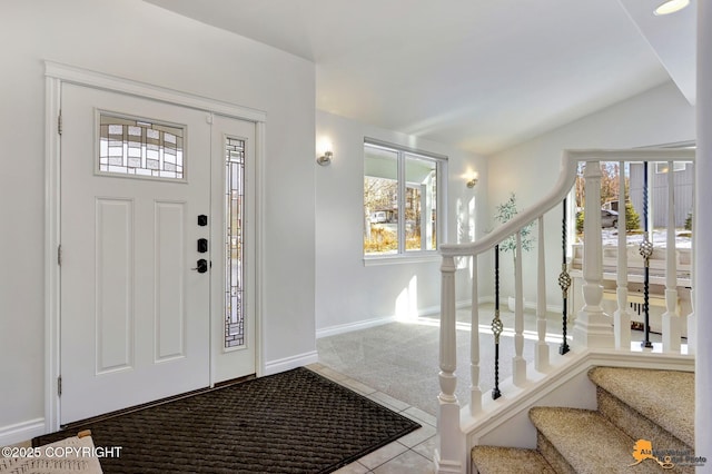 entrance foyer featuring stairs, carpet flooring, and plenty of natural light