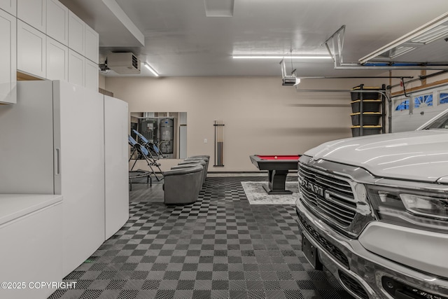 garage with freestanding refrigerator and a garage door opener
