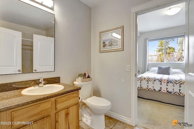 bathroom with connected bathroom, toilet, tile patterned flooring, and vanity