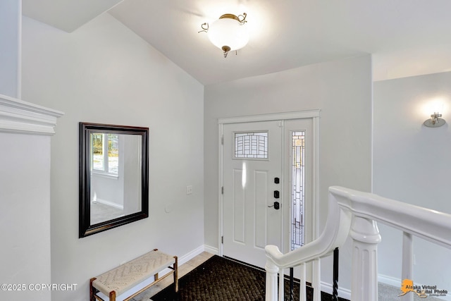 tiled foyer entrance featuring baseboards