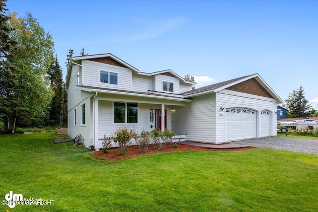 traditional-style house with a garage, driveway, and a front lawn