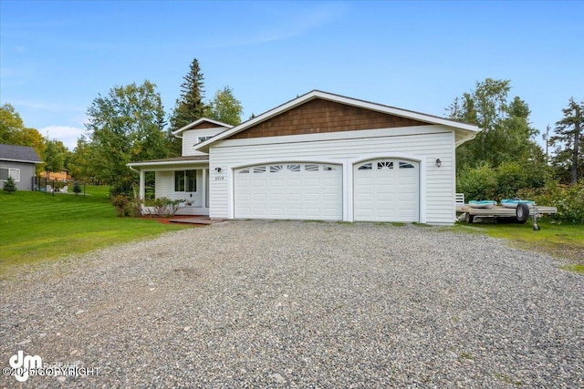 view of front of property featuring an attached garage, driveway, and a front lawn