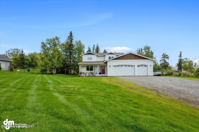 traditional-style house featuring an attached garage, driveway, and a front lawn