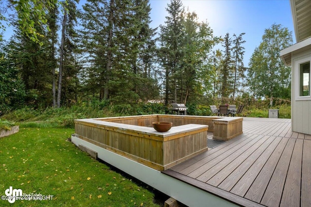 wooden terrace with outdoor dining area, a yard, and a grill