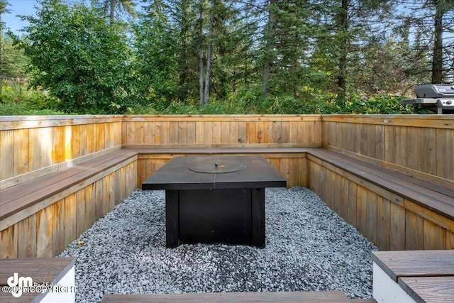exterior space featuring fence and an outdoor fire pit