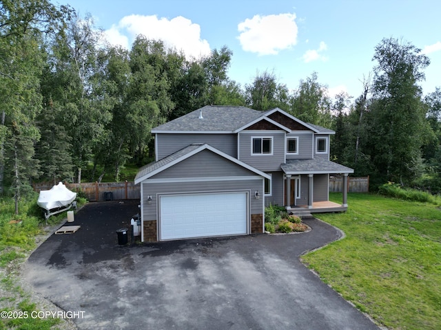7779 N Showers St, Palmer, AK 99645 - view of front facade with fence, an attached garage, a front lawn, stone siding, and driveway