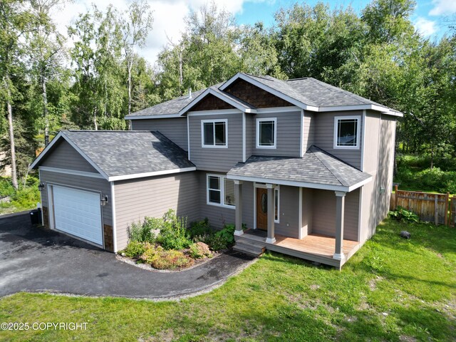 7779 N Showers St, Palmer, AK 99645 - view of front of house featuring roof with shingles, fence, an attached garage, aphalt driveway, and a front yard