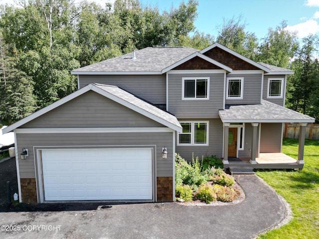 7779 N Showers St, Palmer, AK 99645 - craftsman house featuring a porch, a shingled roof, and stone siding