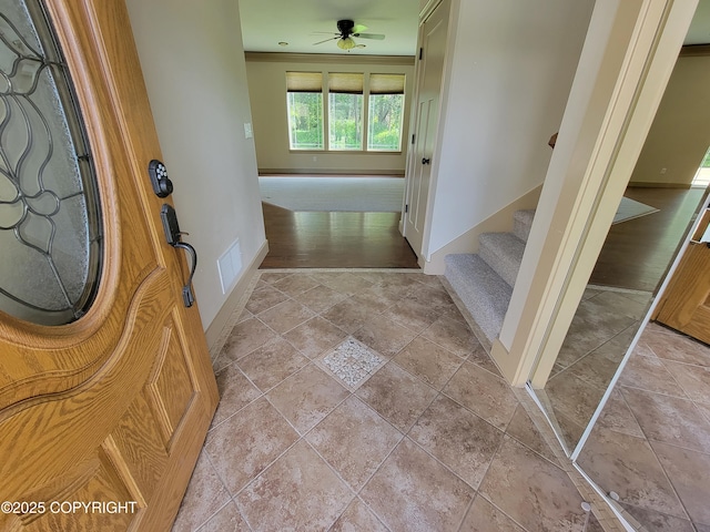 7779 N Showers St, Palmer, AK 99645 - entrance foyer with ceiling fan, visible vents, stairway, baseboards, and stone tile floors