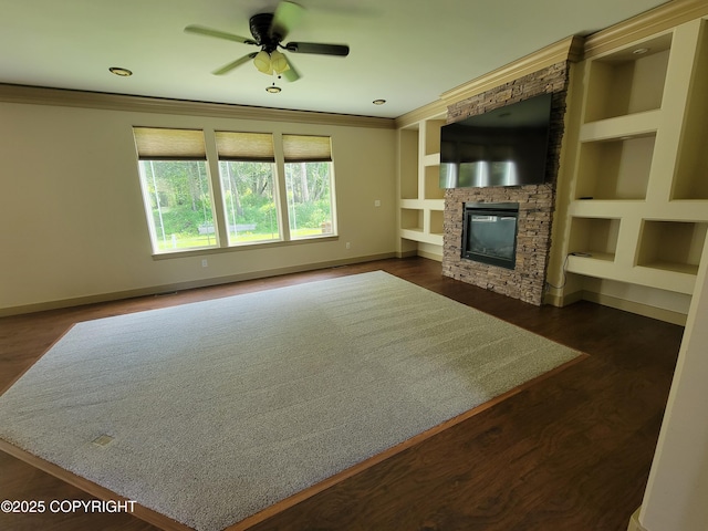 7779 N Showers St, Palmer, AK 99645 - unfurnished living room featuring a stone fireplace, a ceiling fan, baseboards, and built in shelves