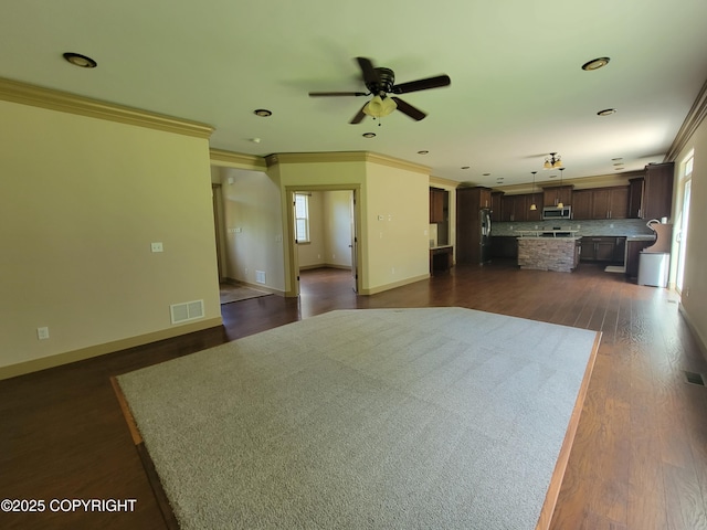 7779 N Showers St, Palmer, AK 99645 - living area with ceiling fan, visible vents, dark wood finished floors, baseboards, and ornamental molding