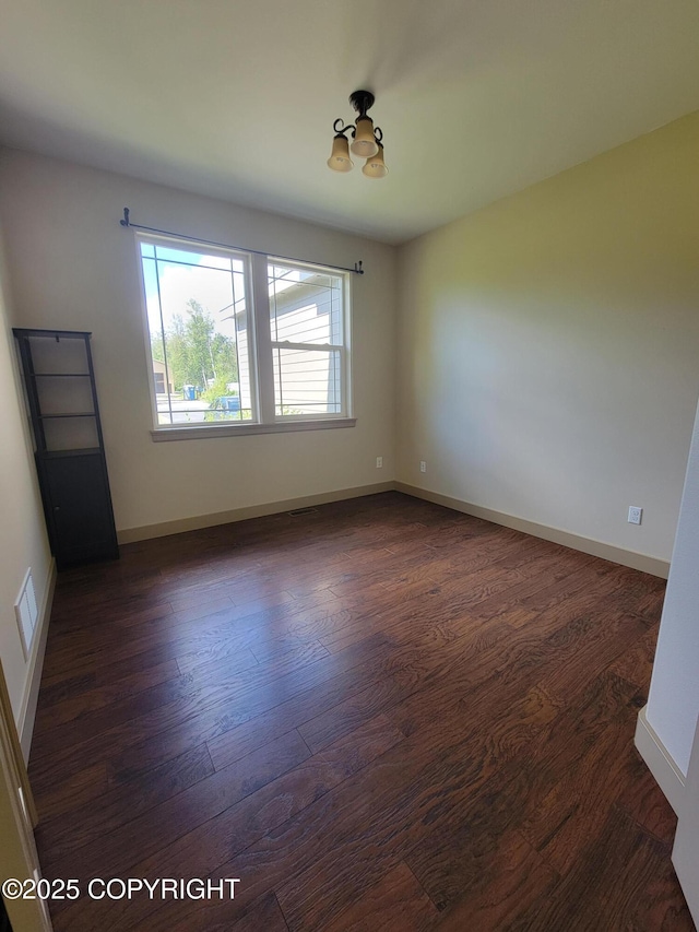 7779 N Showers St, Palmer, AK 99645 - empty room featuring visible vents, dark wood finished floors, and baseboards
