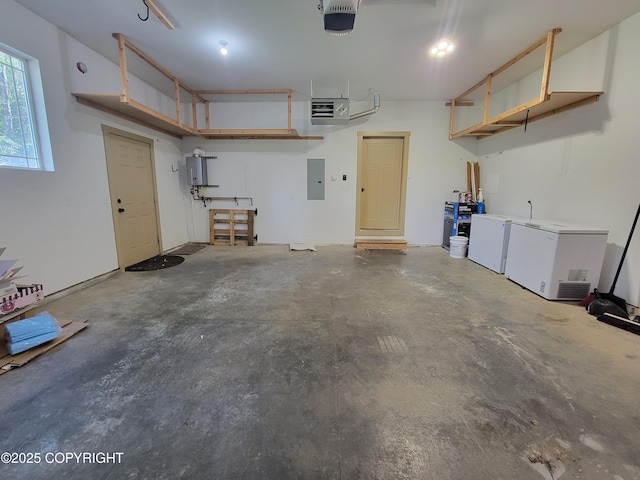 7779 N Showers St, Palmer, AK 99645 - garage featuring a garage door opener, electric panel, and fridge