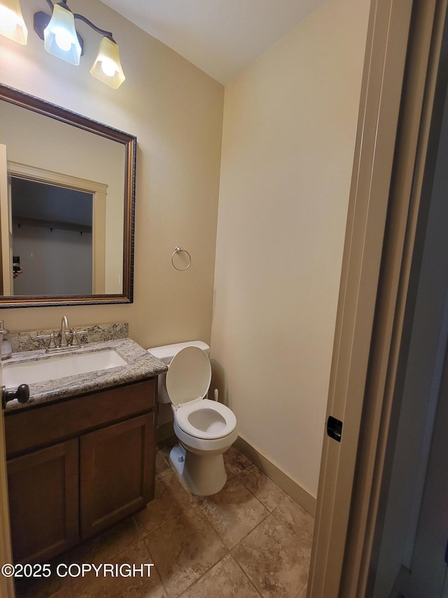 7779 N Showers St, Palmer, AK 99645 - bathroom featuring baseboards, vanity, and toilet