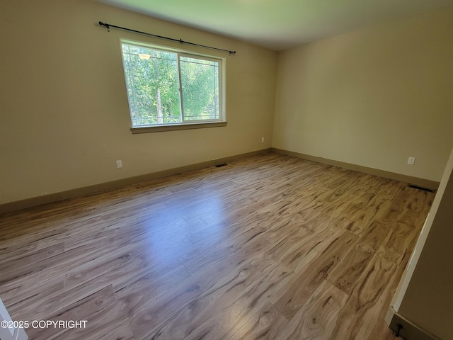 7779 N Showers St, Palmer, AK 99645 - empty room featuring baseboards, visible vents, and wood finished floors