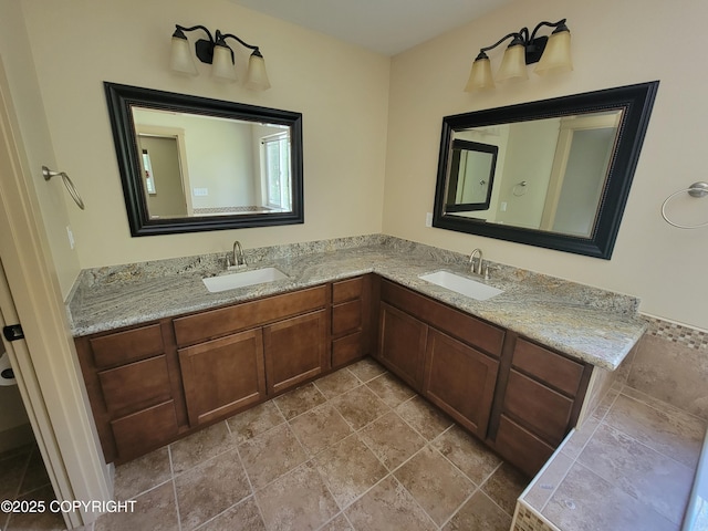 7779 N Showers St, Palmer, AK 99645 - bathroom featuring stone tile flooring, a sink, and double vanity