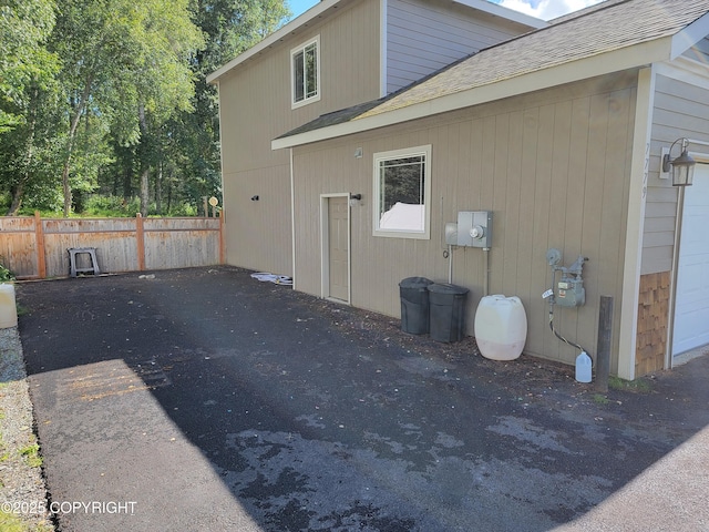 7779 N Showers St, Palmer, AK 99645 - view of side of home with roof with shingles and fence