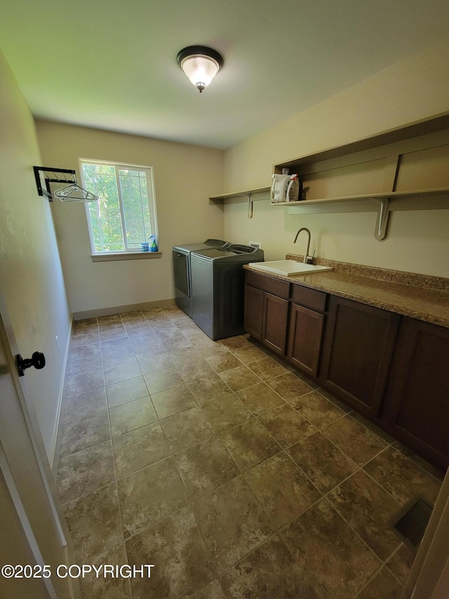 7779 N Showers St, Palmer, AK 99645 - laundry area featuring visible vents, washing machine and clothes dryer, cabinet space, a sink, and baseboards