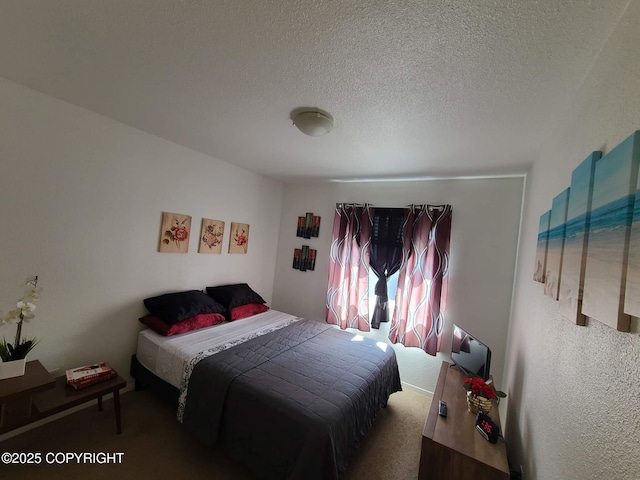 bedroom featuring carpet flooring and a textured ceiling