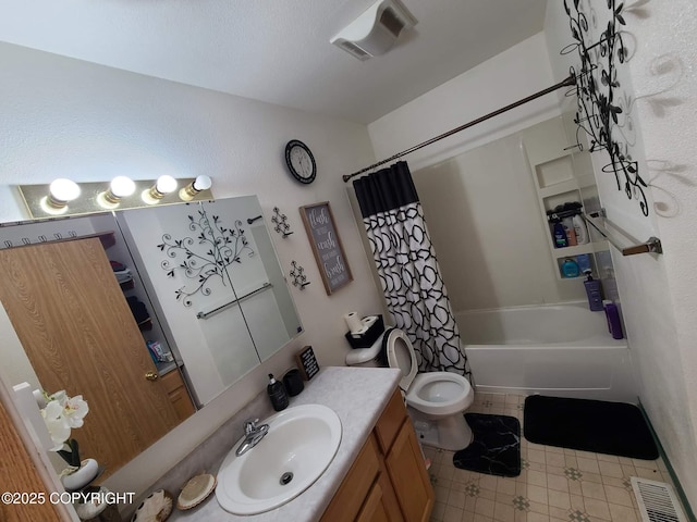 bathroom featuring vanity, tile patterned flooring, visible vents, toilet, and shower / tub combo