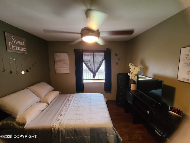 bedroom with ceiling fan and dark wood finished floors