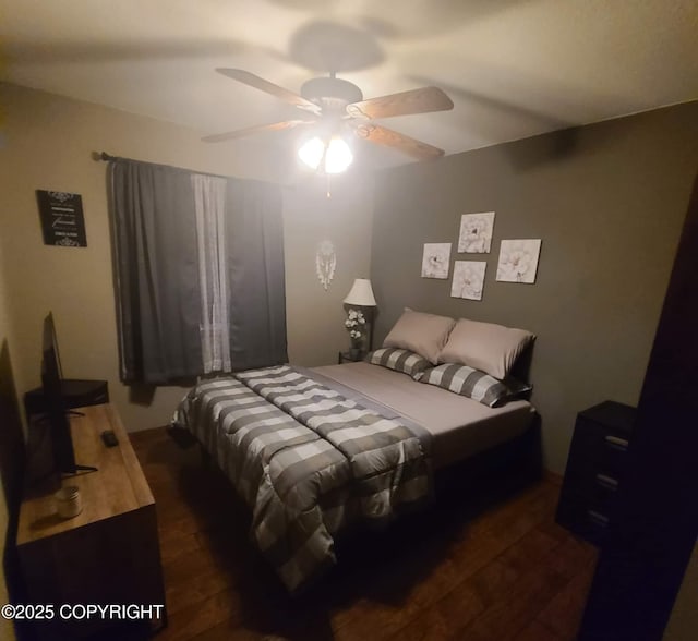 bedroom with dark wood-type flooring and ceiling fan