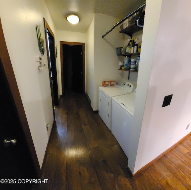 laundry room featuring separate washer and dryer, laundry area, dark wood-style floors, and baseboards