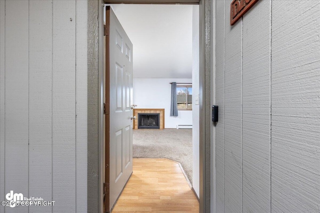 4241 Folker St # D202, Anchorage, AK 99508 - corridor featuring a baseboard radiator and wood finished floors