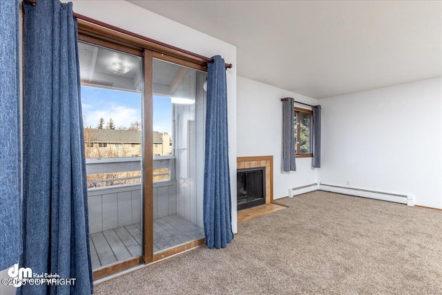 4241 Folker St # D202, Anchorage, AK 99508 - unfurnished living room with carpet flooring, a baseboard heating unit, and a tile fireplace