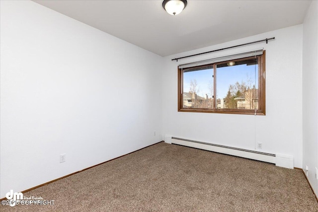 4241 Folker St # D202, Anchorage, AK 99508 - unfurnished room with a baseboard radiator and carpet