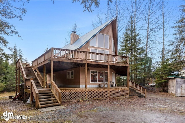 337 Alta Dr, Girdwood, AK 99587 - rear view of house with a deck, a chimney, driveway, and stairway