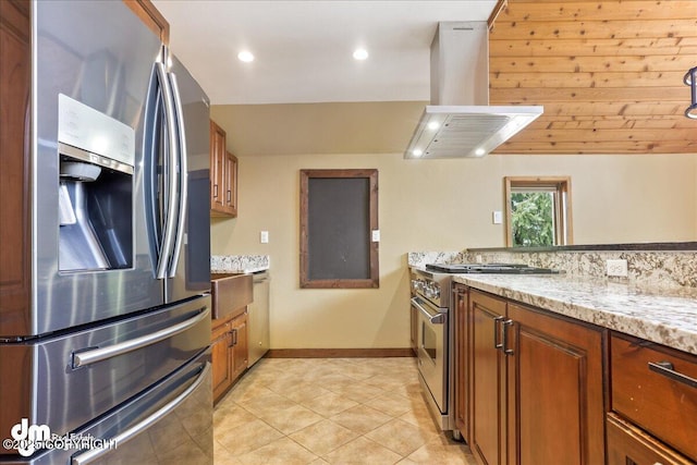 337 Alta Dr, Girdwood, AK 99587 - kitchen with brown cabinets, appliances with stainless steel finishes, and island range hood