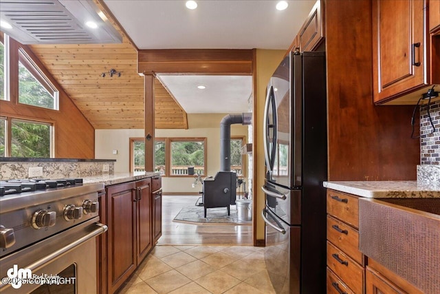 337 Alta Dr, Girdwood, AK 99587 - kitchen with stainless steel appliances, recessed lighting, a wood stove, and tasteful backsplash