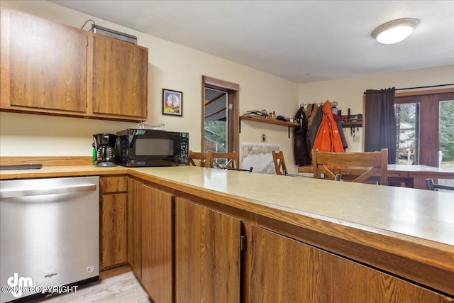 337 Alta Dr, Girdwood, AK 99587 - kitchen with brown cabinets, black microwave, light wood-style floors, light countertops, and dishwasher