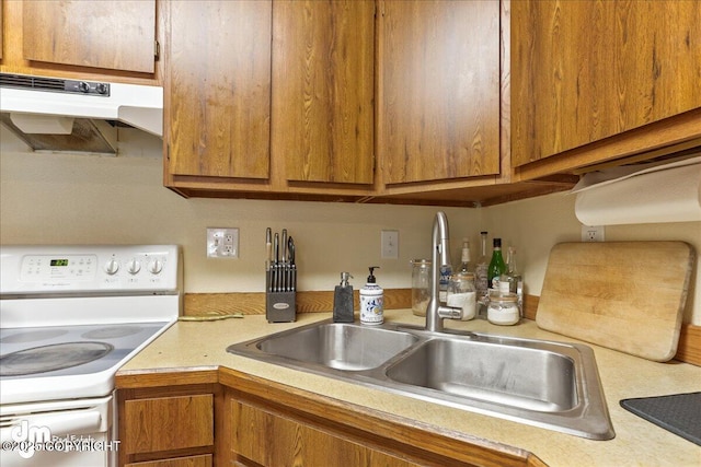337 Alta Dr, Girdwood, AK 99587 - kitchen featuring electric stove, a sink, under cabinet range hood, and light countertops