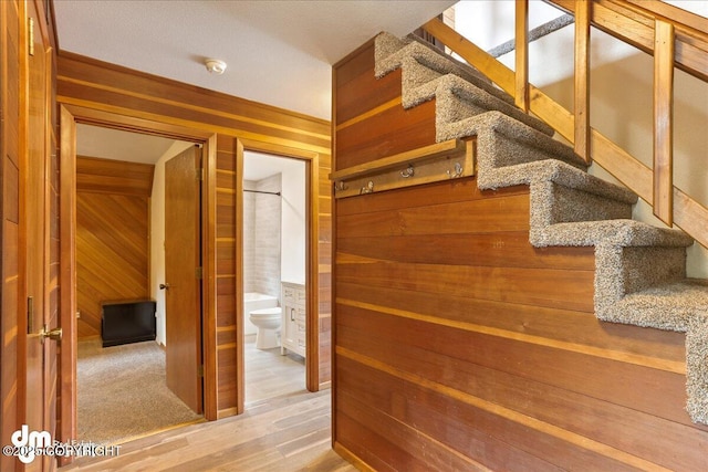 337 Alta Dr, Girdwood, AK 99587 - stairway featuring wood walls and wood finished floors