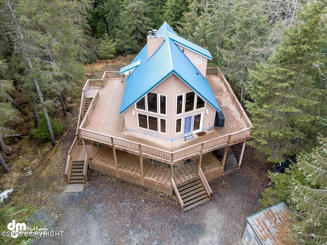 337 Alta Dr, Girdwood, AK 99587 - rear view of property featuring stairway, a wooded view, metal roof, and a chimney