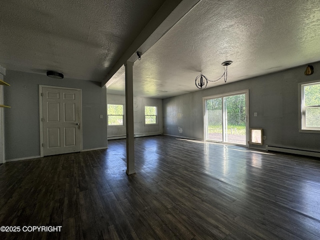 3140 N Brocton Ave, Wasilla, AK 99654 - unfurnished living room featuring dark wood-style flooring, a textured ceiling, a baseboard heating unit, and baseboards